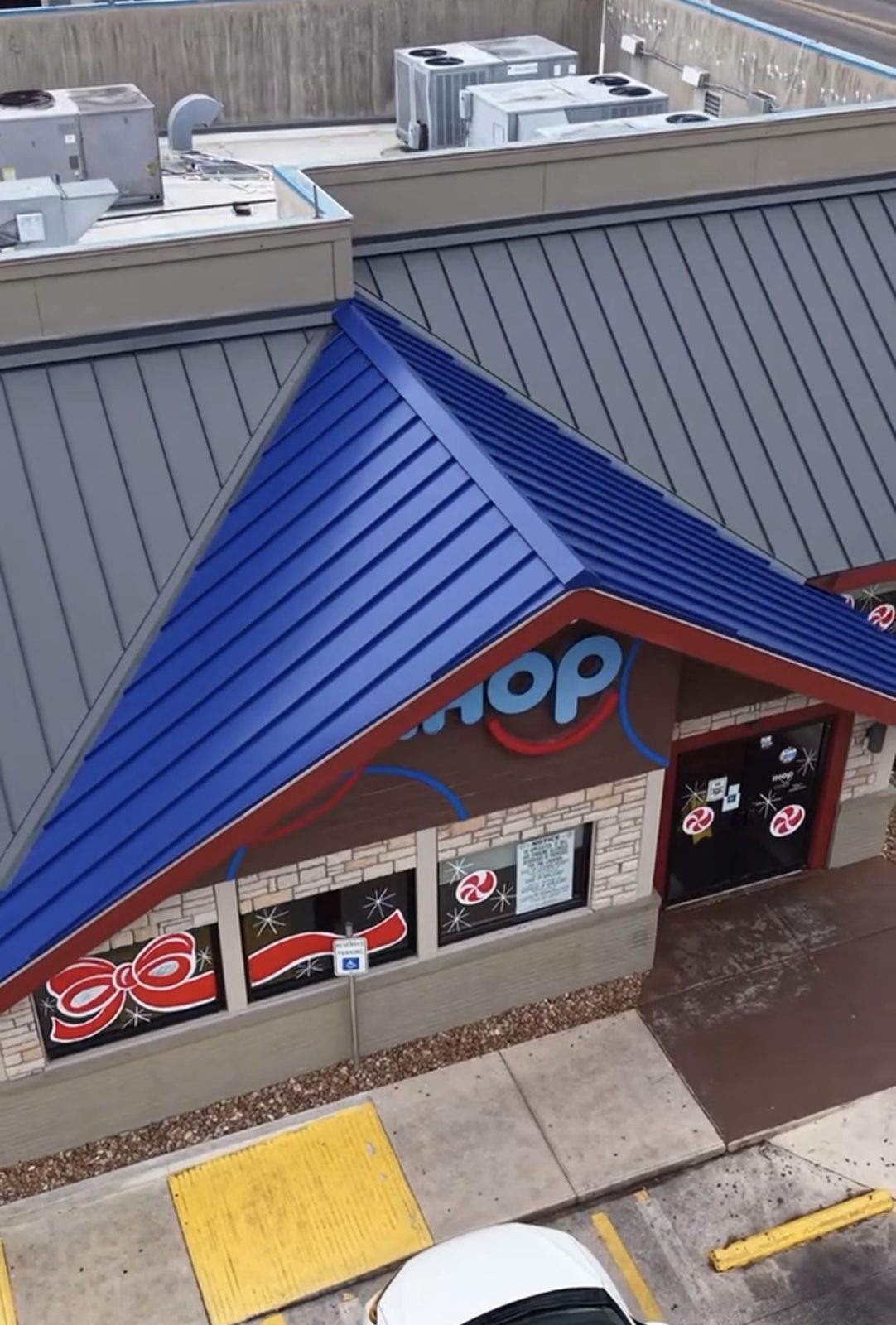 Blue standing seam metal roof on a commercial building