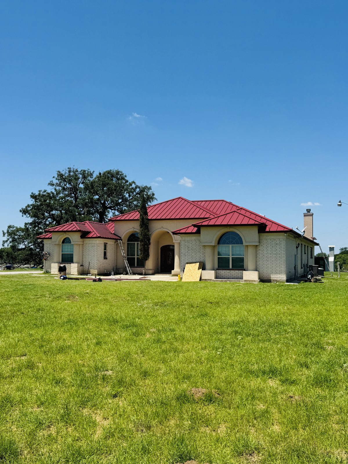 Home with a red standing seam metal roof