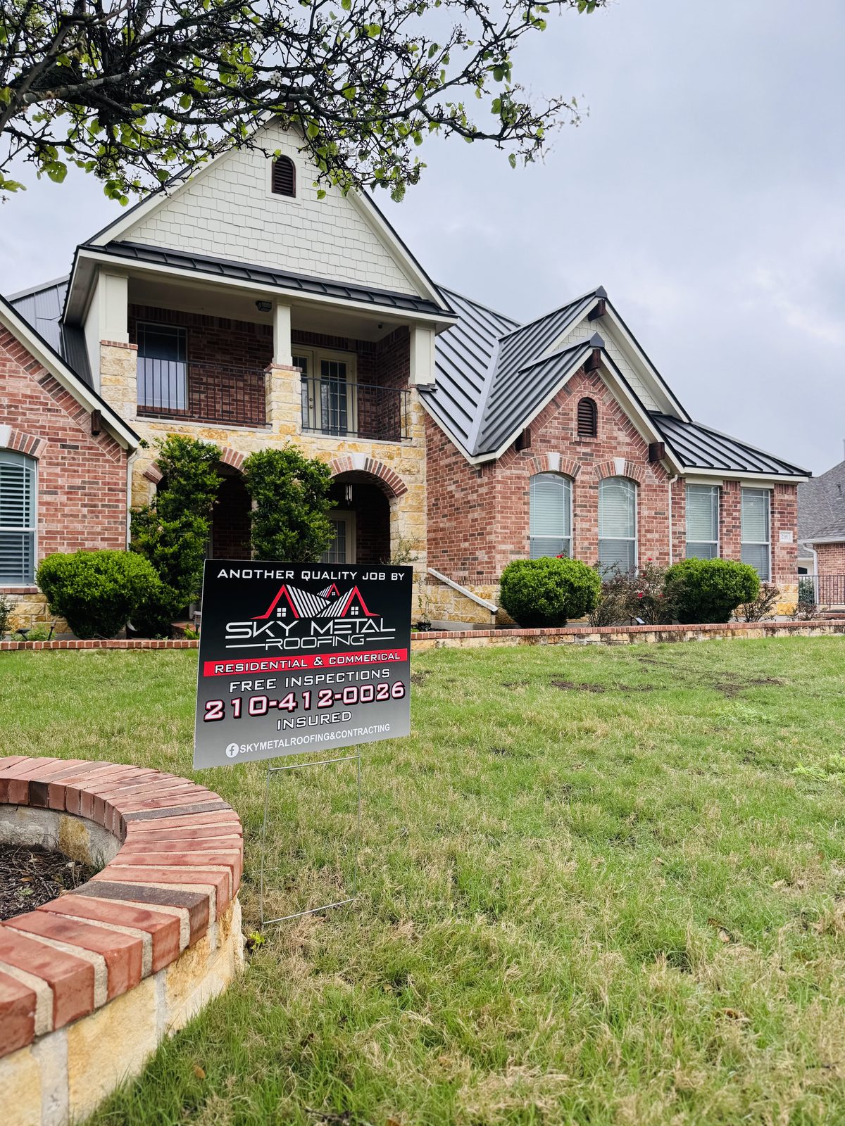 Brick home with a Sky Metal Roofing yard sign